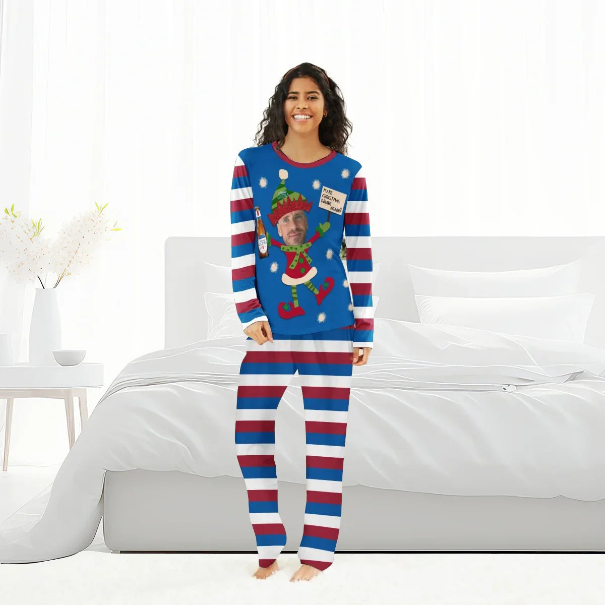 Woman wearing personalized Christmas pajamas with striped red, white, and blue pants and elf design top holding Michelob Ultra beer