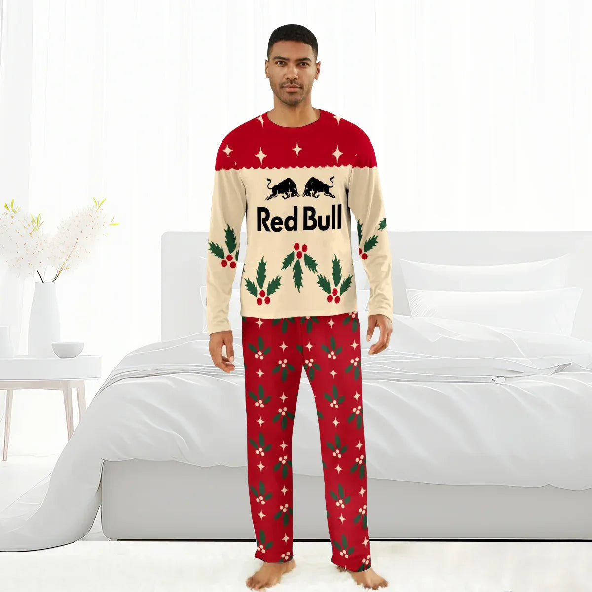 Man wearing Red Bull Christmas cherry holiday pajamas in bright bedroom with white bed and decor