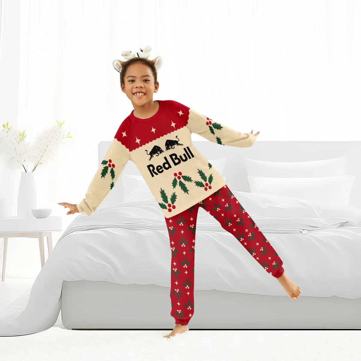 Child wearing Red Bull Christmas cherry family pajamas with festive holly pattern indoors