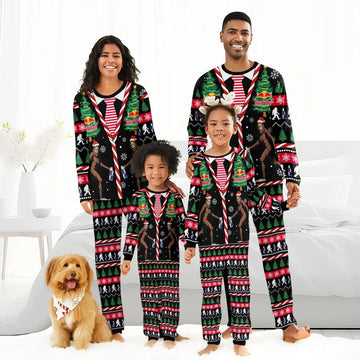 Smiling family and dog in matching Red Bull Christmas Bigfoot pajamas with holiday trees and snowflakes