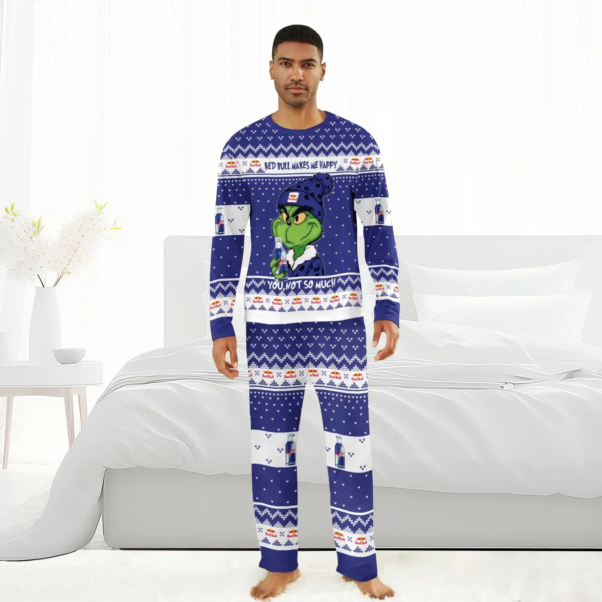Man wearing blue Red Bull Grinch holiday pajamas with festive patterns and text in a bright bedroom