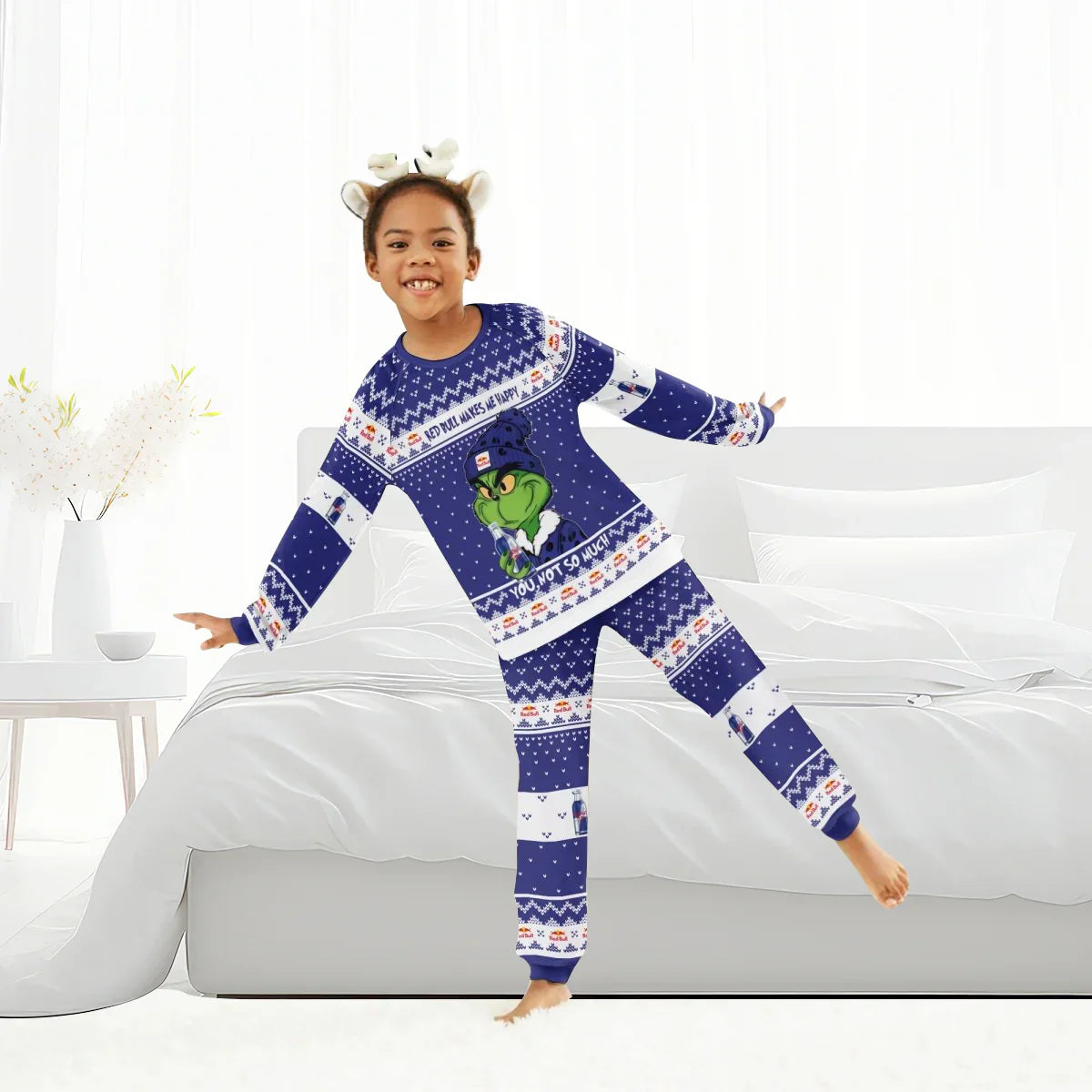 Child wearing Red Bull themed Christmas Grinch family pajamas in a bright bedroom