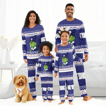 Happy family in matching blue Red Bull Grinch holiday pajamas with dog in festive bandana