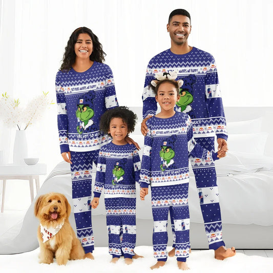 Happy family in matching blue Red Bull Grinch holiday pajamas with dog in festive bandana