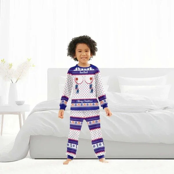 Child wearing Red Bull Merry Christmas family pajamas in festive blue and white pattern, standing in bright bedroom