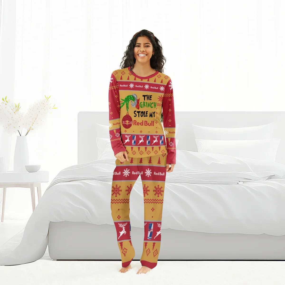 Woman in Christmas pajamas with The Grinch stole my Red Bull design standing in bright bedroom