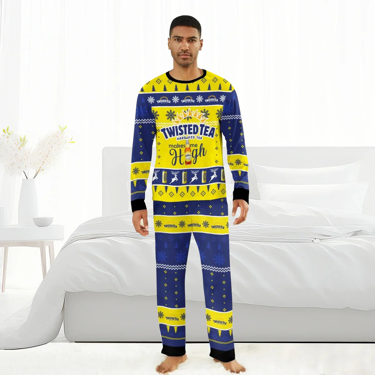 Man wearing blue and yellow Twisted Tea Christmas pajamas with holiday patterns in a bright bedroom