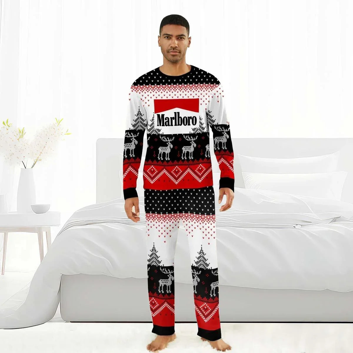 Man wearing Marlboro-themed reindeer family winter pajamas in red, black, and white in a bright bedroom