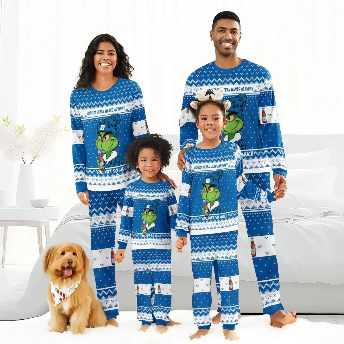 Smiling family wearing matching blue Grinch and Michelob Ultra holiday pajamas in bright living room with dog