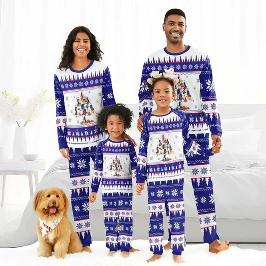Smiling family in matching blue and white Christmas tree pajamas with snowflake patterns, with a dog wearing a holiday bandana